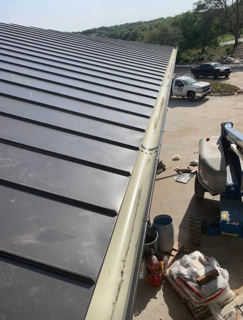 Standing seam panel and gutter detail on a metal roofing jobsite in Sacramento